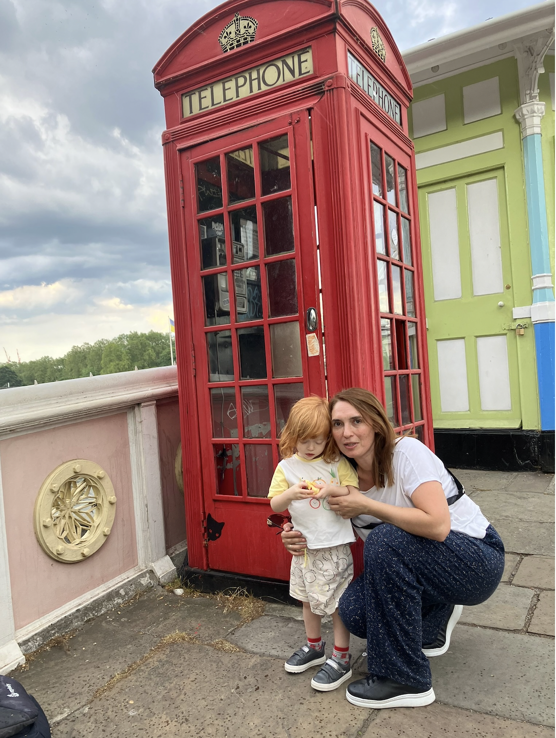 Lucien beside a red British telephone box